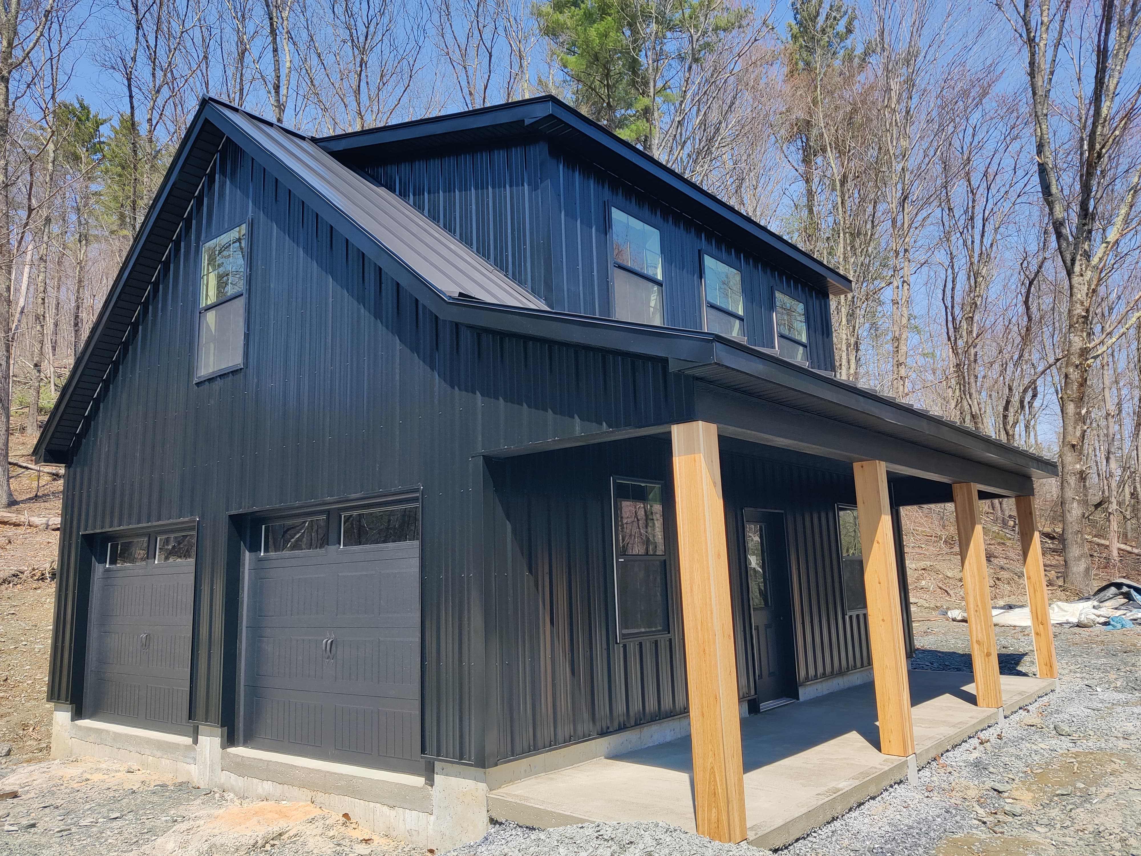 Black glossy Tuff Rib Ag metal siding on a two-car garage in Albany, NY