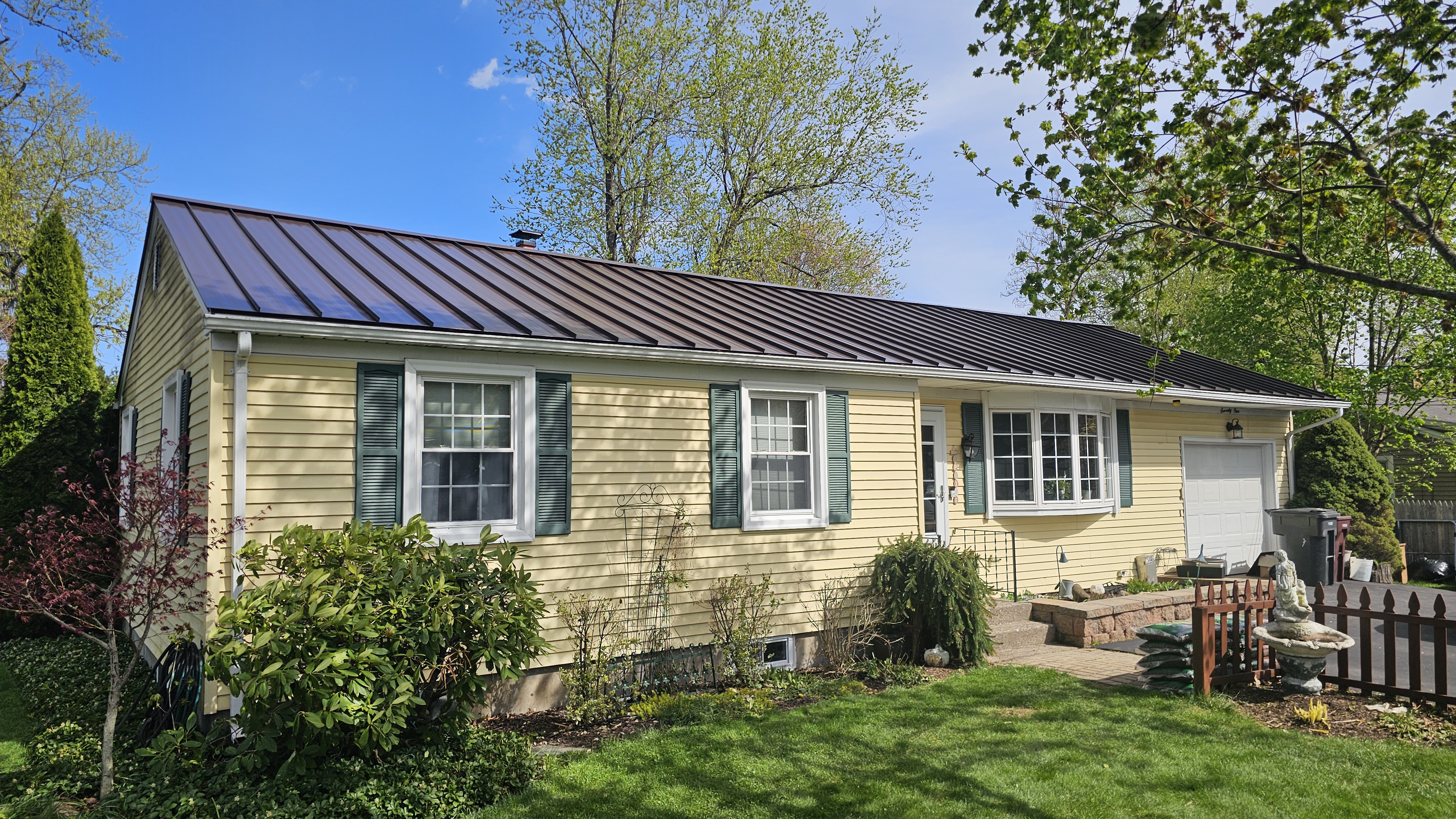 Dark Bronze Snap Lock Standing Seam with Striations metal roof on a ranch house in Westfield, MA, front view
